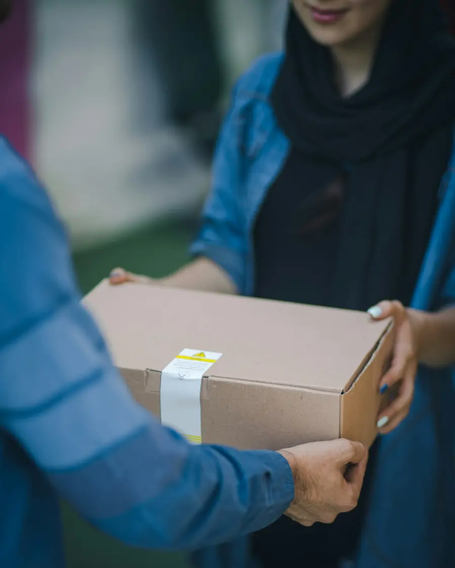 Mover handing a packed box to a customer