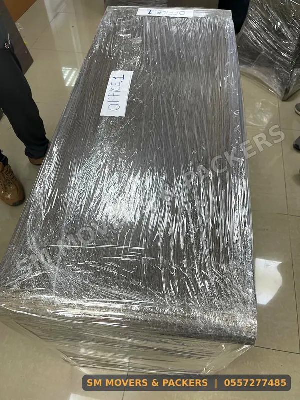 Desk wrapped in stretch film