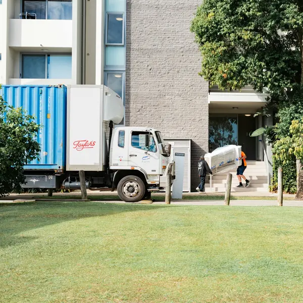 Moving truck being loaded outside a building