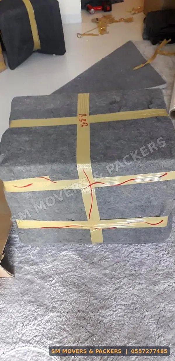 Sofa wrapped in a moving blanket